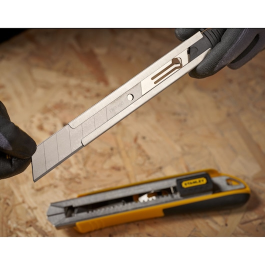 STANLEY 0-11-325 snap-off blade utility knife with segmented replacement blade on work surface.