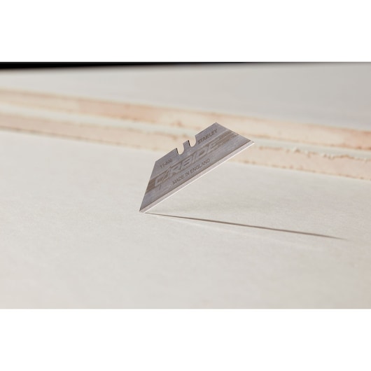 STANLEY 0-11-800 utility knife blade standing on edge, close-up with white background.