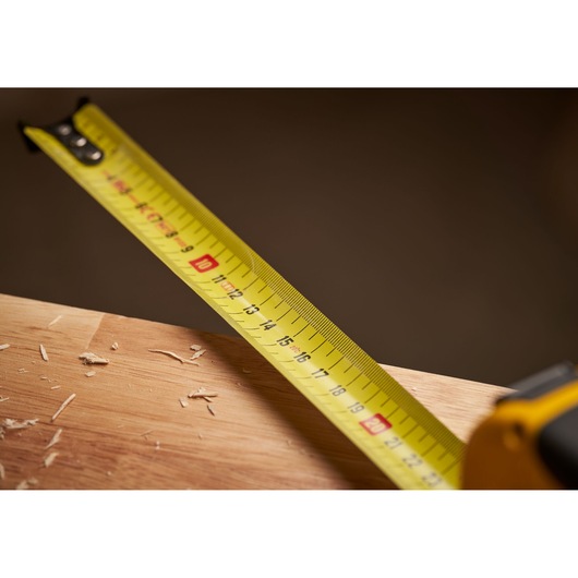 STANLEY 0-33-811 yellow tape measure photography close-up on wood surface.