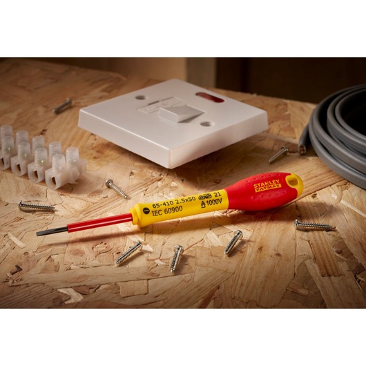 Stanley 0-65-410 electrical screwdriver, red and yellow handle, photographed on plywood with wiring and screws.