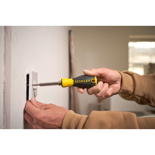 STANLEY 0-68-012 screwdriver with yellow and black handle used to install a wall socket.
