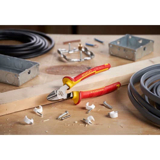 STANLEY 0-84-009 insulated diagonal pliers on a wood workbench with cables and hardware, photography.