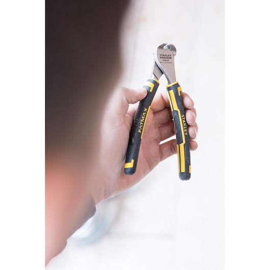 Photo of STANLEY 0-89-875 FATMAX end cutting pliers with black and yellow handles held in a hand.