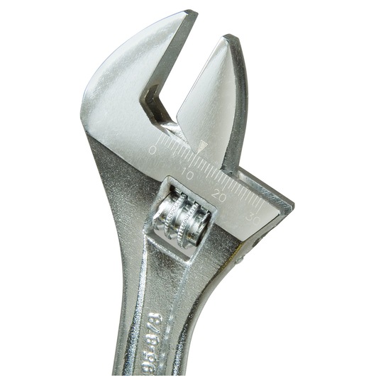 Close-up of a metal adjustable wrench with measurement markings on the jaw.