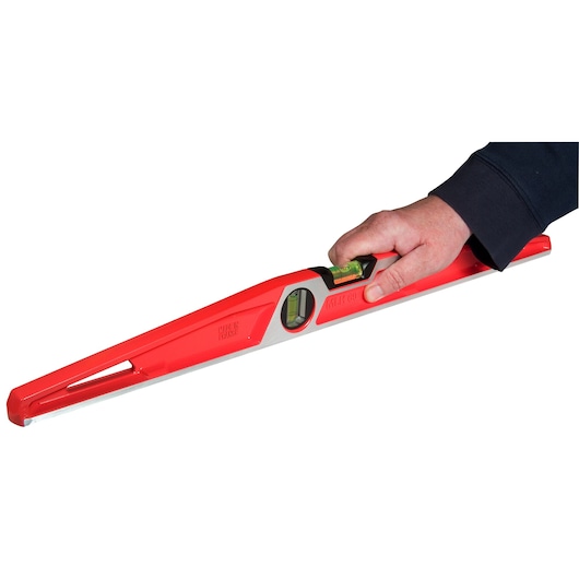 STANLEY 1-42-314 spirit level with red body, digital display, and vial, hand holding tool, side angle.