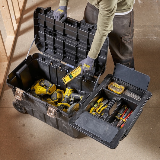 STANLEY 1-92-978 tool box open with hand tools and power tools, shown from above in workshop setting.