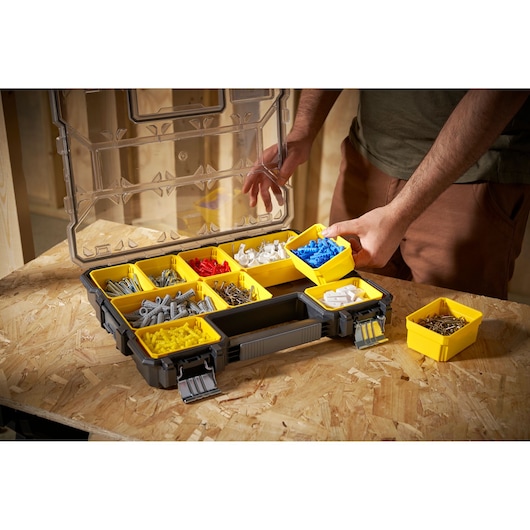 STANLEY 1-97-517 organizer with yellow removable bins filled with assorted fasteners, photo at workbench angle.