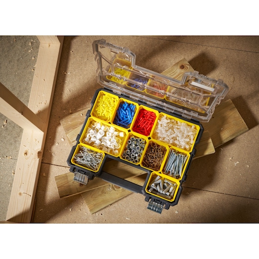 STANLEY 1-97-517 organiser box with assorted fasteners photographed from above on workshop floor.