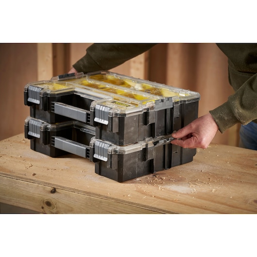 STANLEY 1-97-521 stackable organizer case with clear lid on workbench, side-angle photo.