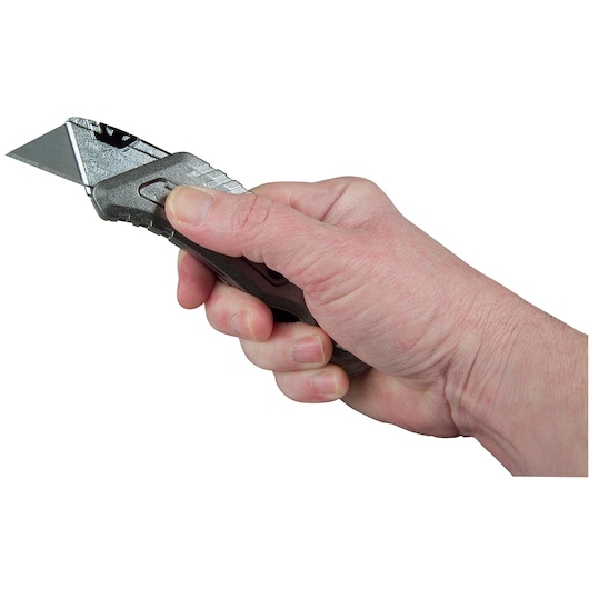 STANLEY 9-10-813 utility knife held in hand, side angle, silver blade and textured black handle.