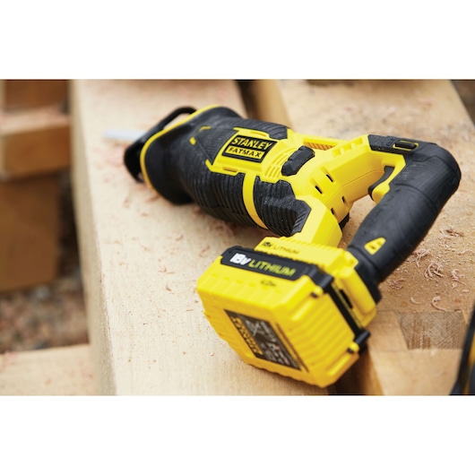 STANLEY FMC675B cordless reciprocating saw in yellow and black on a wooden work surface.