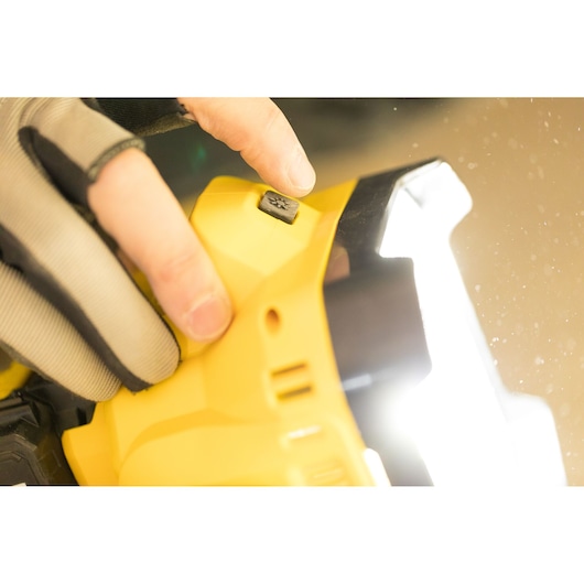 STANLEY FMCL001B work light close-up, button detail, person wearing glove, photo of product in use.