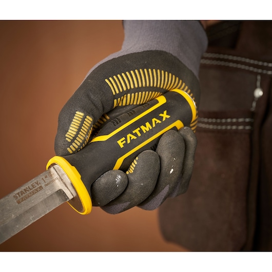 STANLEY FMHT16693-0 chisel with FATMAX handle, held in gloved hand, close-up photo.