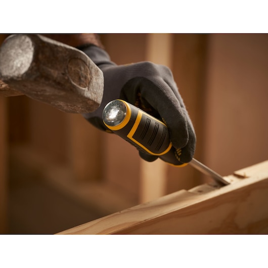 Photo of STANLEY FMHT16693-0 chisel with hand guard and bi-material handle in use on wood, close-up angle.