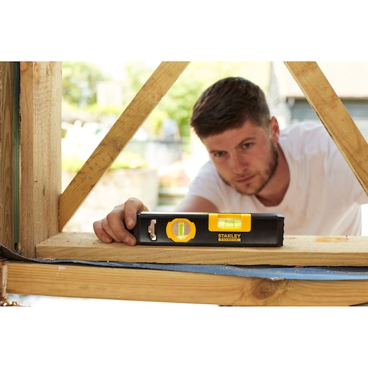 Stanley FMHT42884-1 spirit level in use on timber during construction, photography outdoor.