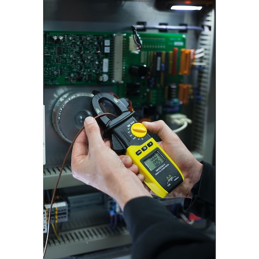 Photo of STANLEY FMHT82564-0 digital clamp meter used to measure current in electrical panel.