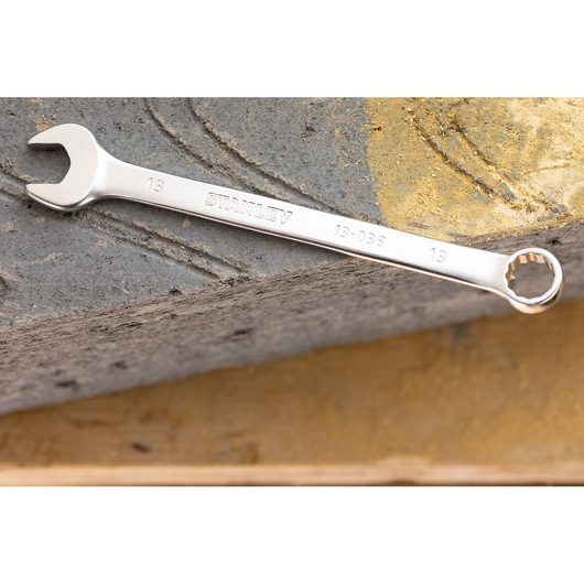STANLEY FMMT13035-0 combination wrench in silver, photography of tool placed on stone surface.