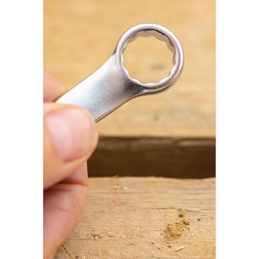 Photo of STANLEY FMMT13041-0 box-end wrench held by hand, close-up on metallic finish.
