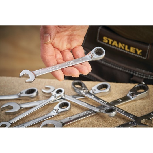 STANLEY FMMT13082-0 photography of silver combination wrenches, hand holding one above work surface.