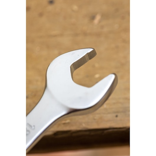 Stanley FMMT13096-0 open-end wrench close-up, photography of silver metal tool on wooden surface.