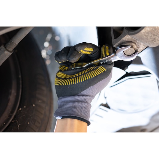 STANLEY FMMT13111-0 spanner used on bolt by gloved hand, automotive maintenance context.