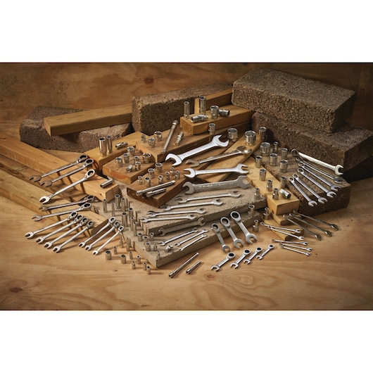STANLEY FMMT17197-0 photography of assorted wrenches and sockets on wood and concrete blocks.