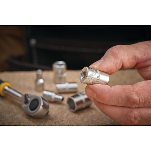 STANLEY FMMT17207-0 socket held in hand, silver finish, other sockets and ratchet tool in background.