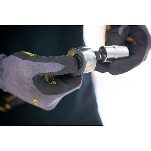 Photo of STANLEY FMMT17239-0 socket tool held by gloved hands, close-up view.