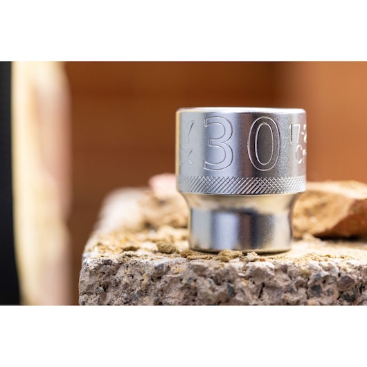 STANLEY FMMT17240-0 socket, 30mm, silver, close-up photo on rough concrete, tool category.