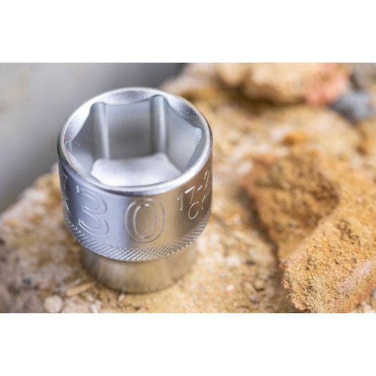 STANLEY FMMT17244-0 socket, silver finish, placed on rocky surface, close-up angle.