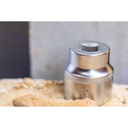 STANLEY FMMT82680-0 chrome socket, close-up, on sandy surface with textured grip visible.