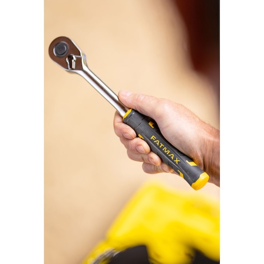 STANLEY FMMT82685-1 ratchet wrench with black and yellow FATMAX handle held in hand, side view.