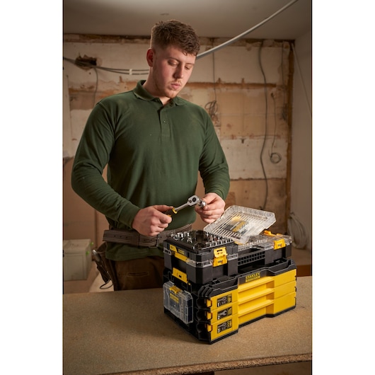 Photo of STANLEY FMMT98102-0 tool storage stack in workshop with person using ratchet and socket.