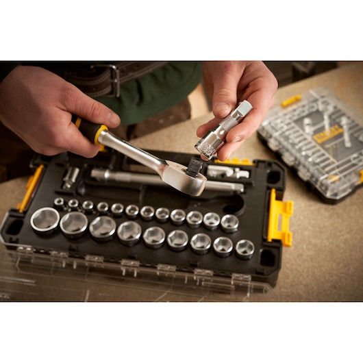 STANLEY FMMT98103-1 socket wrench set displayed in case, hand holding ratchet and socket, photography angle from above.