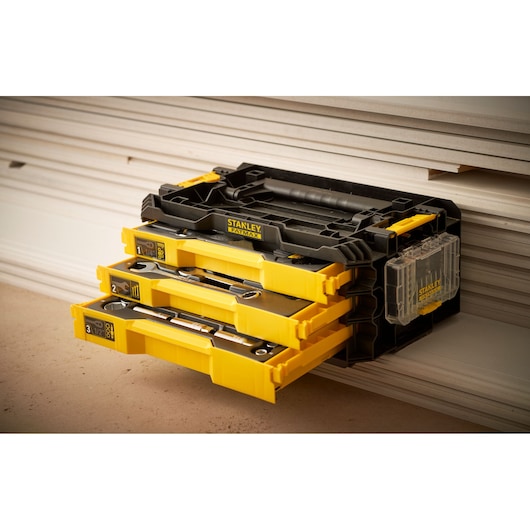 STANLEY FMMT98107-1 tool organizer with three yellow drawers and labeled compartments, side view.