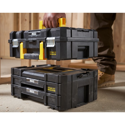 Photo of STANLEY FMST1-71981 toolboxes, black with yellow accents, stackable and with metal latches.