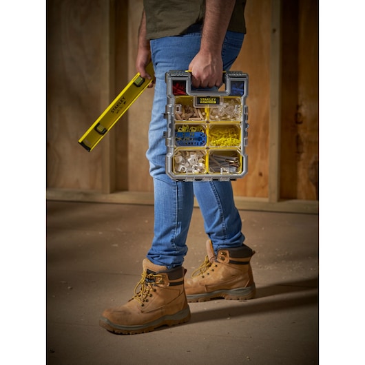 STANLEY FMST1-72378 organizer box with compartments, handheld, shown with level tool, photography.