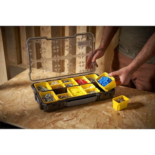 STANLEY FMST1-75779 organizer box with yellow compartments holding various screws and fasteners, photo at angle.