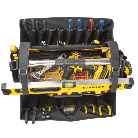 STANLEY FMST1-80146 open tool bag filled with hand tools, screwdriver set, spirit level, and power drill, top view.