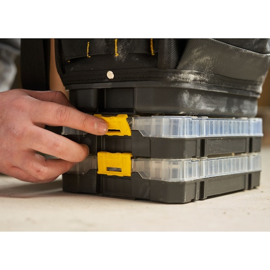 Photo of STANLEY FMST17624-1 stackable black and yellow plastic organizer boxes with clear lids being latched.