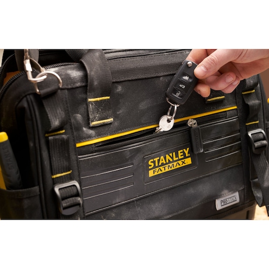 STANLEY FMST17627-1 tool bag close-up with yellow trim and key being attached, photo from front angle.