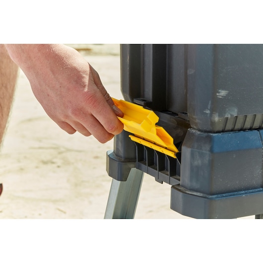 STANLEY FMST81083-1 toolbox yellow latch detail held by hand, photography from side angle.