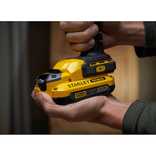 STANLEY SFMCL050B 18V FATMAX V20 Pivot Light, yellow handheld, close-up in hand.