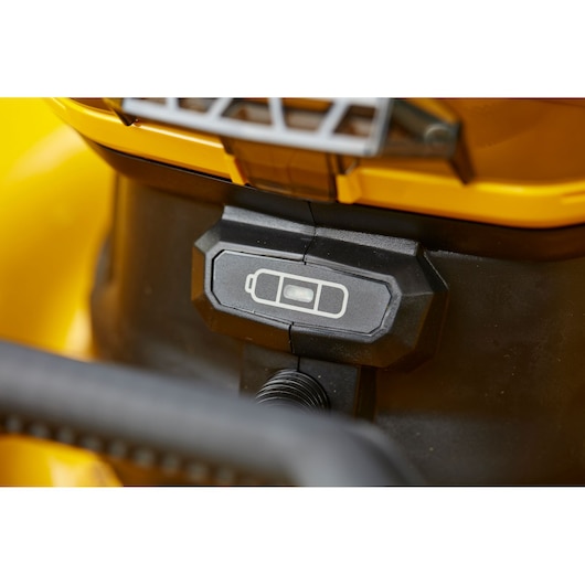 STANLEY SFMCMW2653B battery indicator close-up on yellow lawn mower, showing battery level.