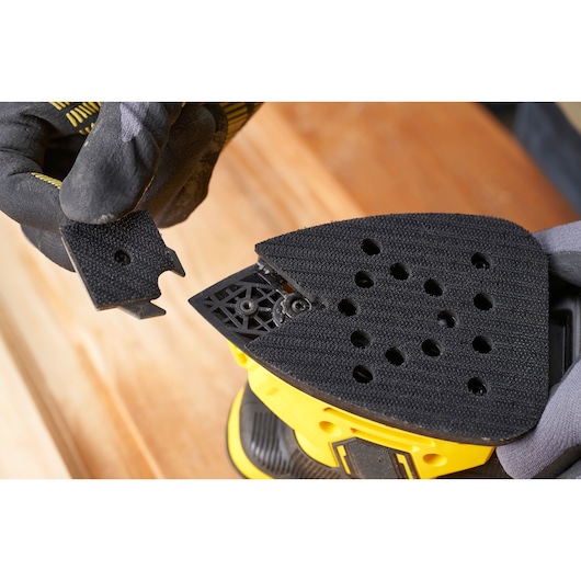 STANLEY SFMEW210S detail sander pad with detachable tip, close-up photo on wood surface.