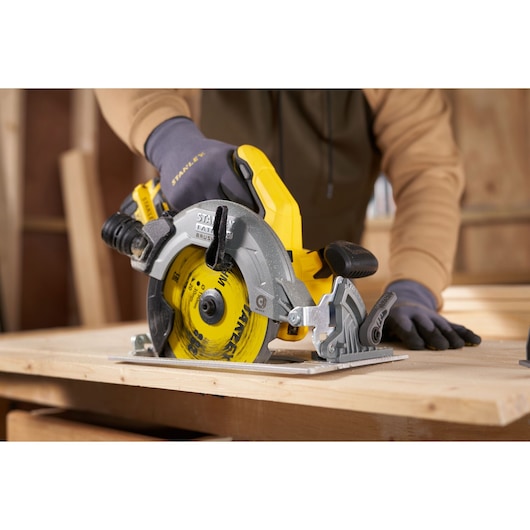 STANLEY STA13030 circular saw in use cutting wood, close-up view in workshop setting.