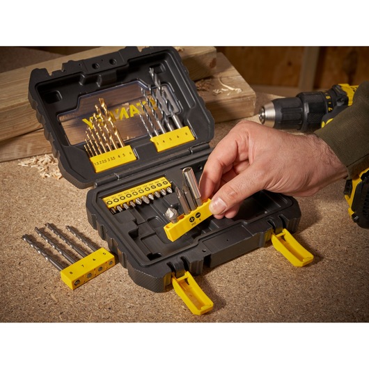 STANLEY STA88550 drill and bit set case on workbench, hand selecting bit holder, photo from above.
