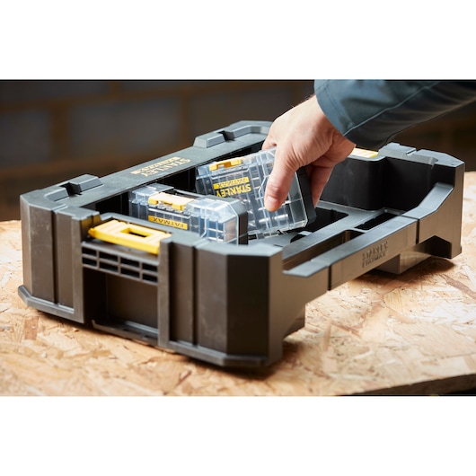 Photo of STANLEY STA88555 organizer, black plastic tray with clear storage cases and yellow latches, angled view.