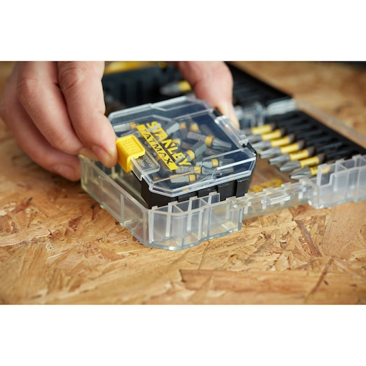 STANLEY STA88569 bit set case with yellow latch, close-up on wood surface.