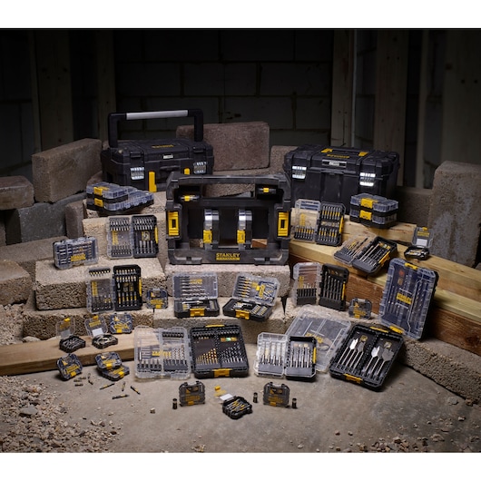 STANLEY STA88572 drill and bit set assortment photography, black and yellow cases on construction site.